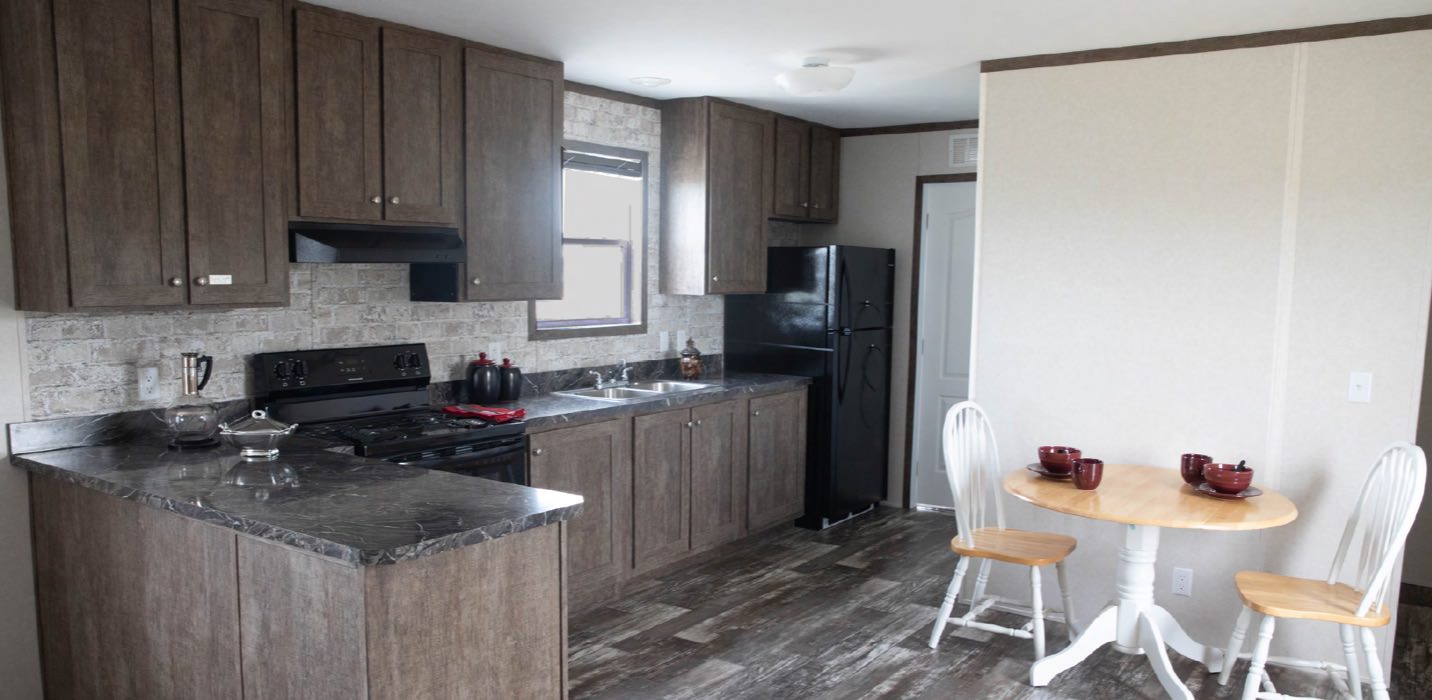 sample kitchen in a manufactured home with laminate cupboards and counters