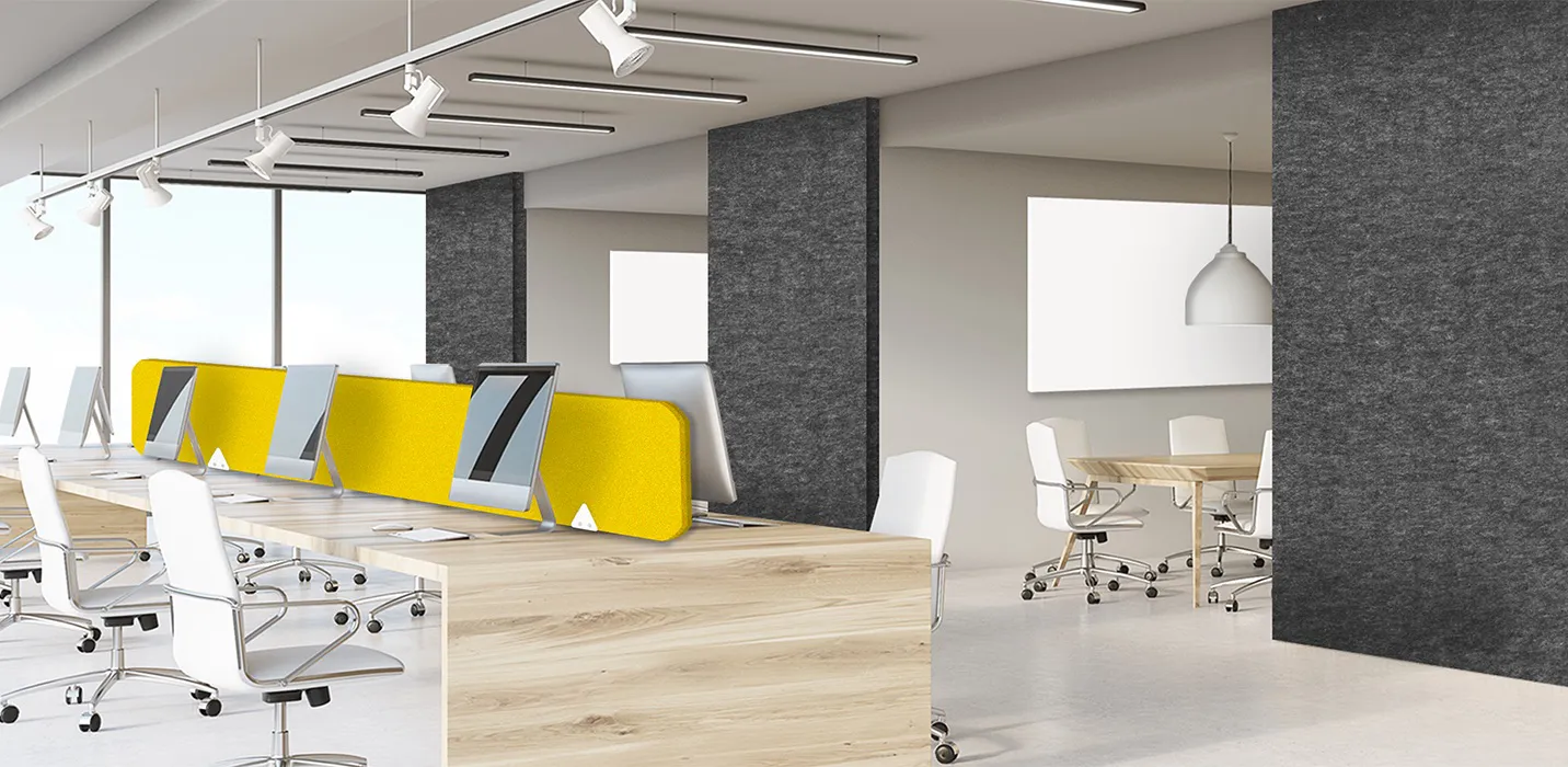 An office with workstations has an acoustic office divider made by Genesis Products