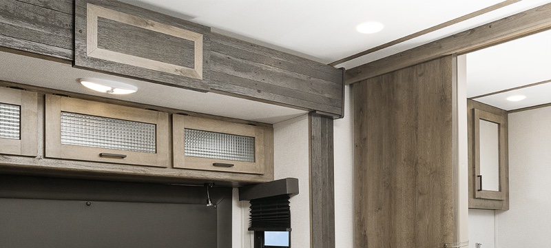 The interior living area of an RV decked out with 2-tone cabinets and trim
