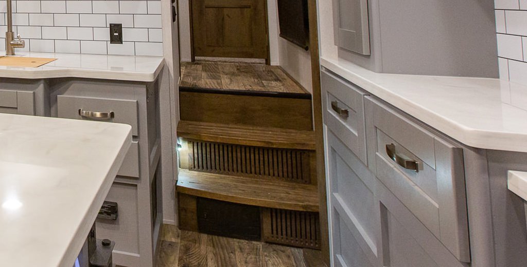 Wooden stairs inside of an RV.